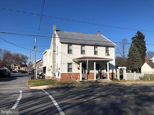 view of front of property with solar panels and a porch