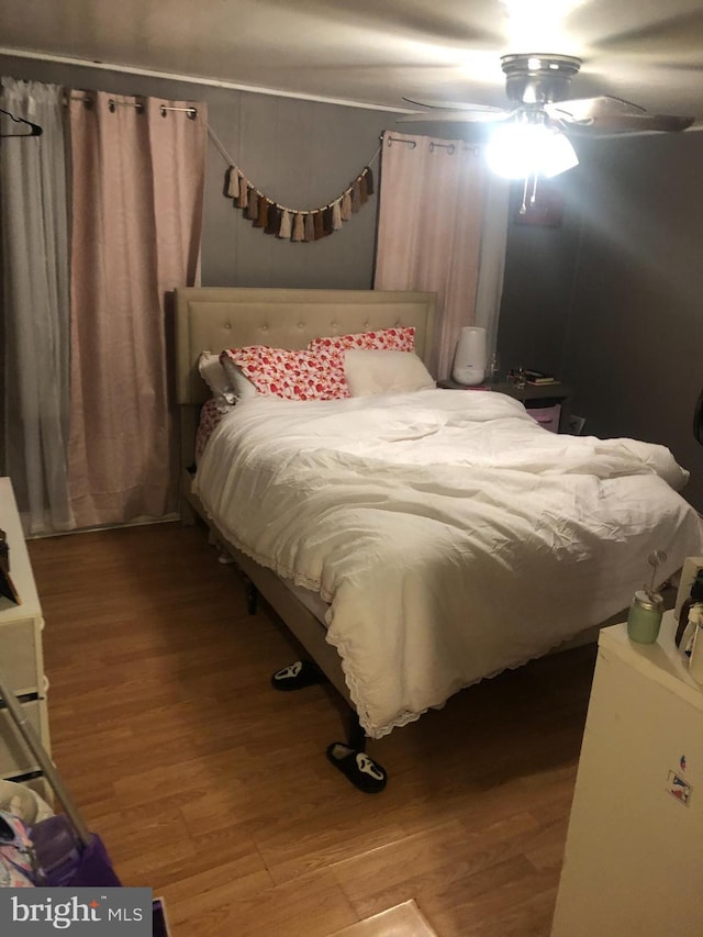 bedroom with ceiling fan and wood-type flooring