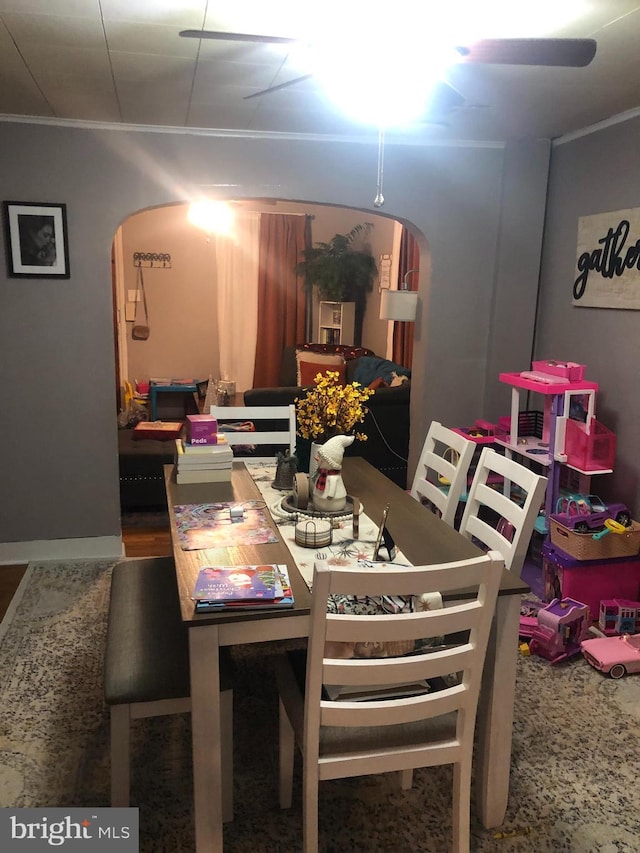 dining space with crown molding