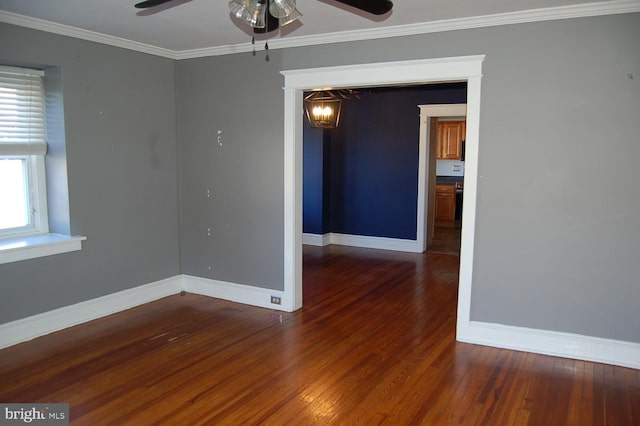 unfurnished room with crown molding, ceiling fan, and dark wood-type flooring