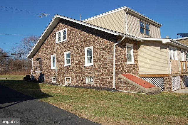 view of property exterior with a yard