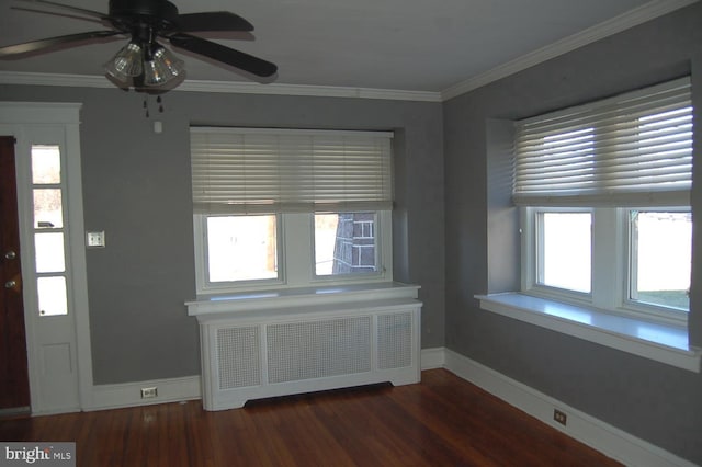 interior space with ceiling fan, crown molding, radiator heating unit, and dark wood-type flooring