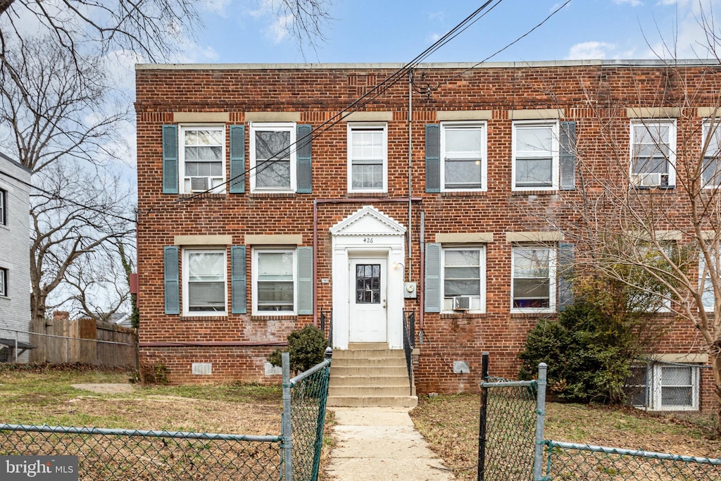 426 Brandywine St SE, Washington, DC 20032 - view of property with entry steps, brick siding, and a fenced front yard