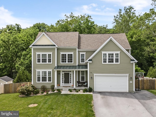 view of front of home featuring covered porch, a front yard, and a garage