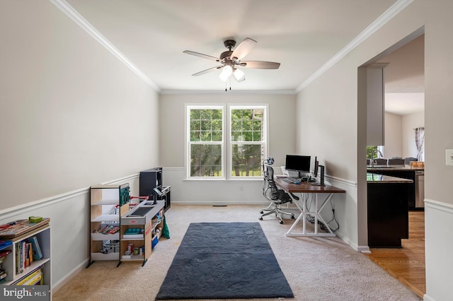 carpeted home office featuring ceiling fan, ornamental molding, and sink