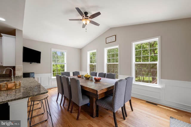 dining area with a healthy amount of sunlight, sink, and light hardwood / wood-style floors