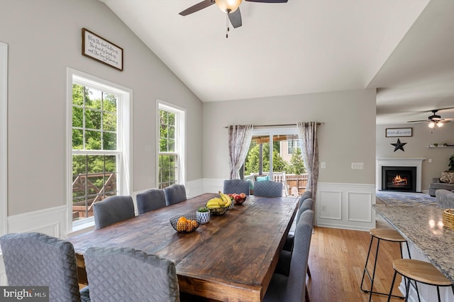 dining area with ceiling fan, light hardwood / wood-style flooring, and lofted ceiling