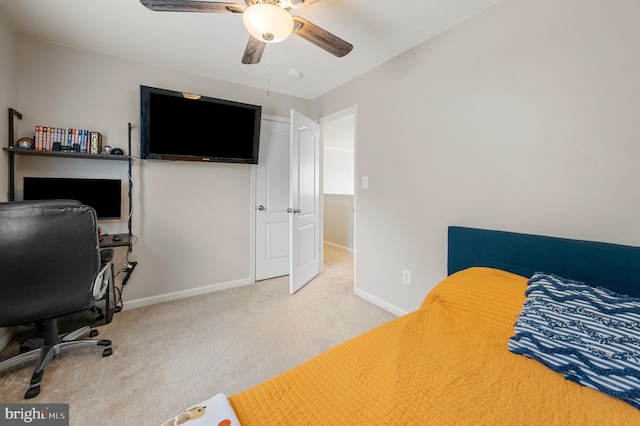 bedroom with ceiling fan and light carpet