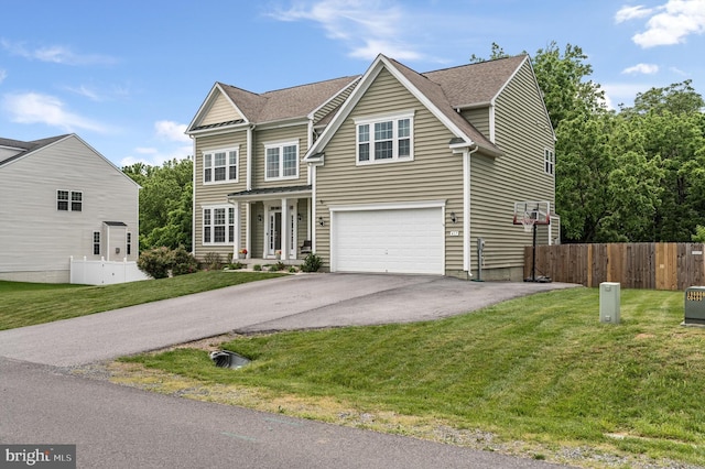 view of front of property with a front yard and a garage