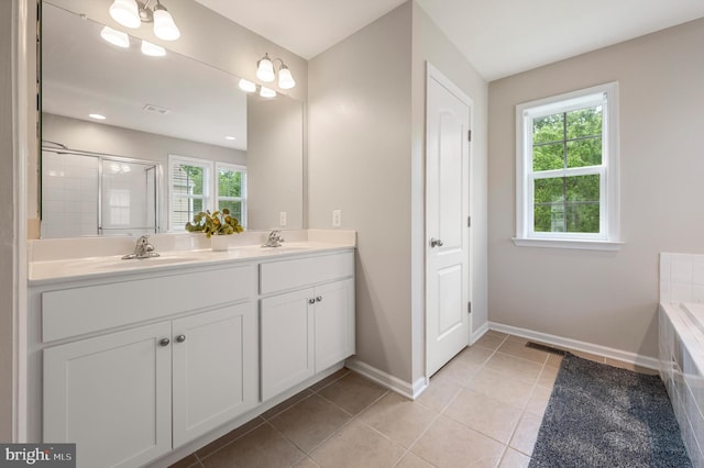 bathroom with tile patterned floors, vanity, a shower with shower door, and an inviting chandelier