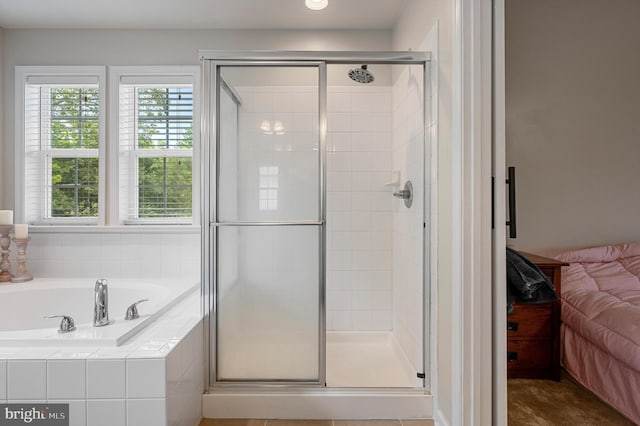 bathroom featuring independent shower and bath