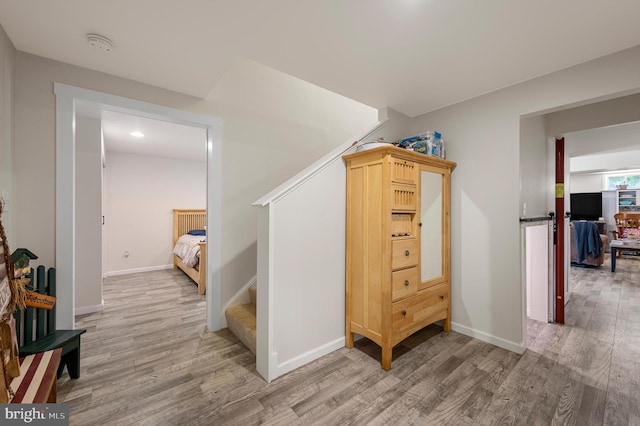 hall with hardwood / wood-style floors