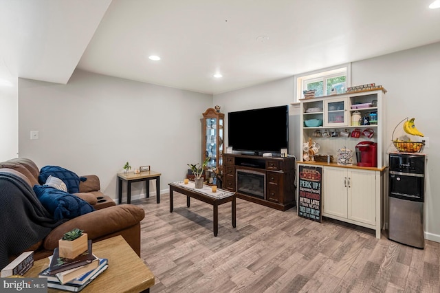 living room with light wood-type flooring and a fireplace