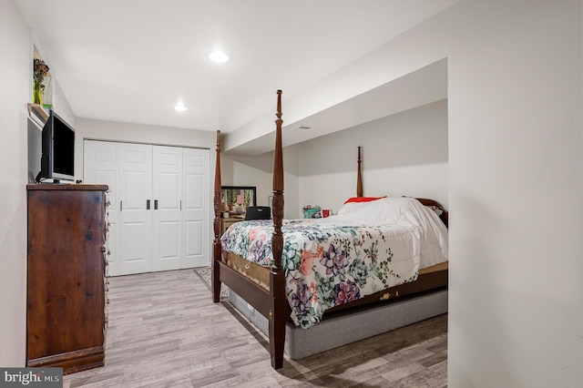 bedroom with a closet and light hardwood / wood-style flooring