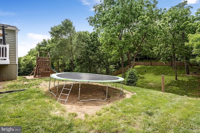 view of yard featuring a playground and a trampoline