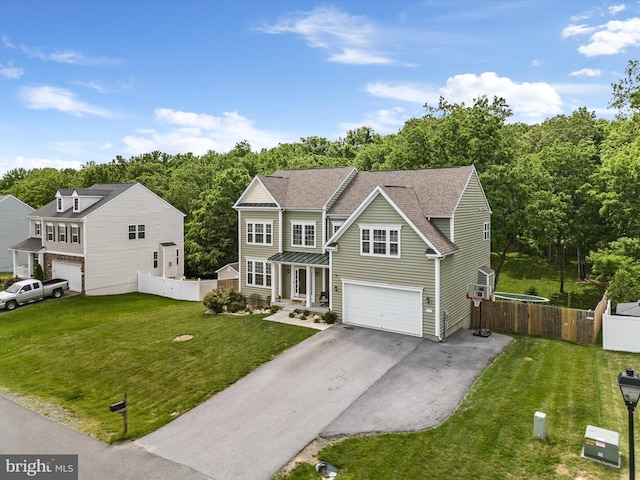 view of front of home with a garage and a front lawn