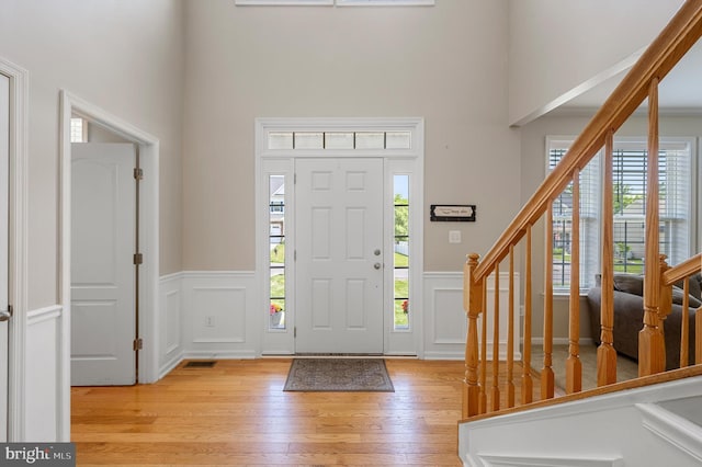 foyer entrance with light hardwood / wood-style floors