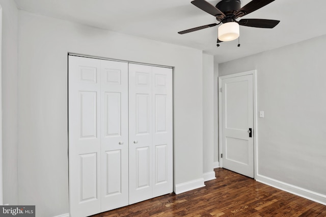 unfurnished bedroom with a closet, ceiling fan, and dark wood-type flooring