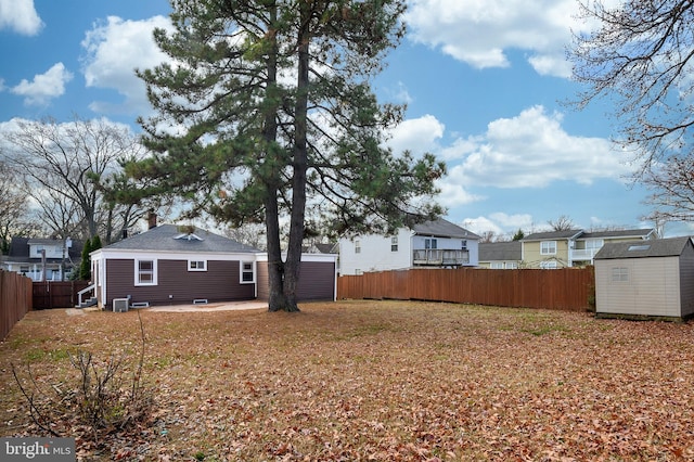 view of yard with a patio and a storage shed