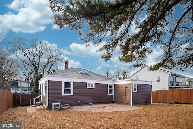 rear view of property with central AC unit