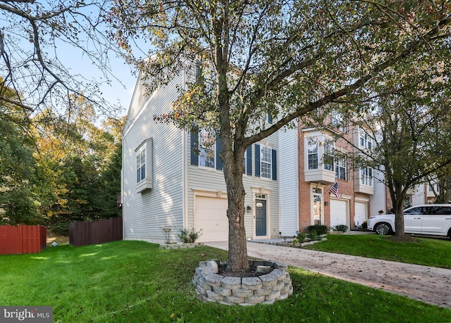 view of front of house with a garage and a front yard