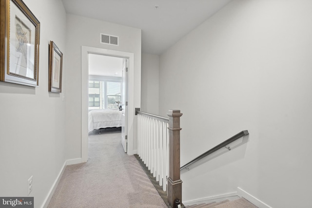 hallway with light carpet