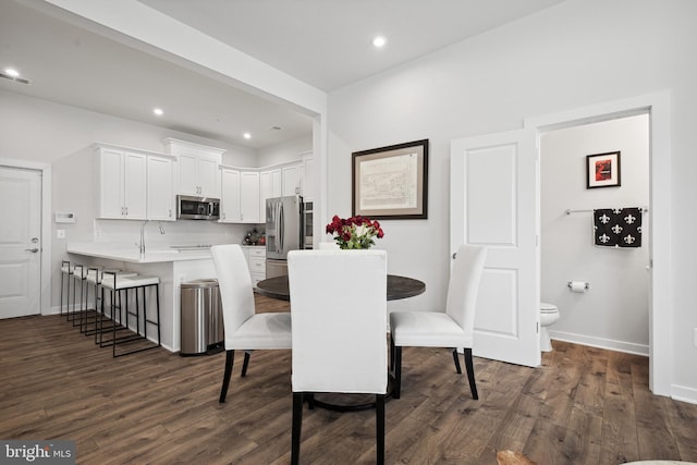 dining area featuring dark hardwood / wood-style flooring and sink