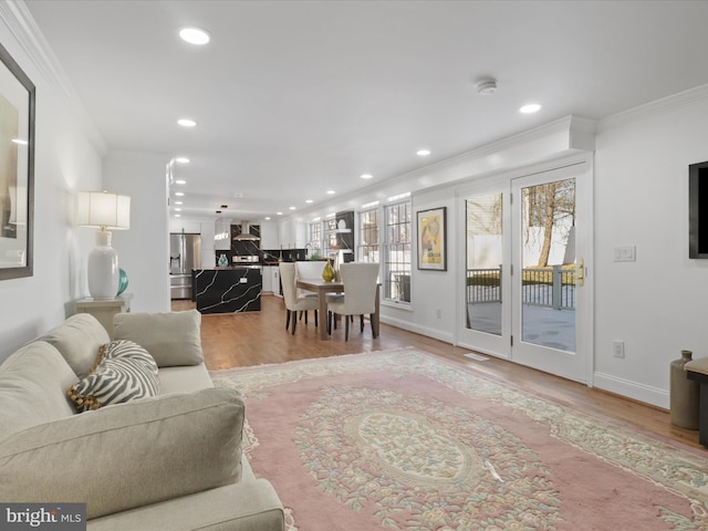 living room featuring hardwood / wood-style flooring and crown molding