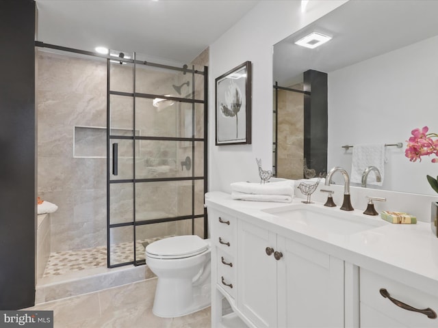 bathroom with vanity, toilet, walk in shower, and tile patterned floors