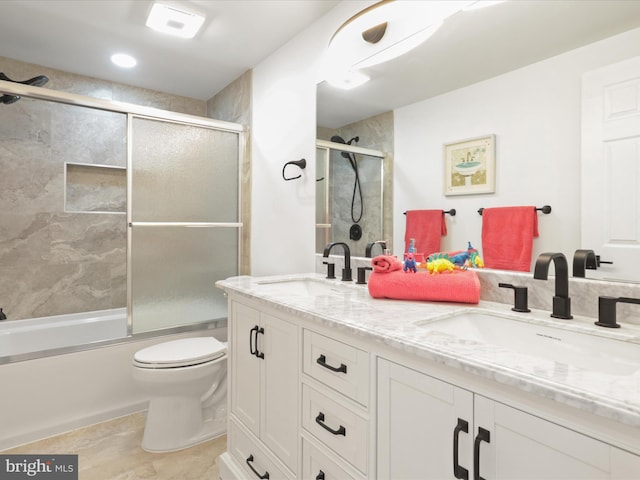 full bathroom with shower / bath combination with glass door, vanity, and toilet