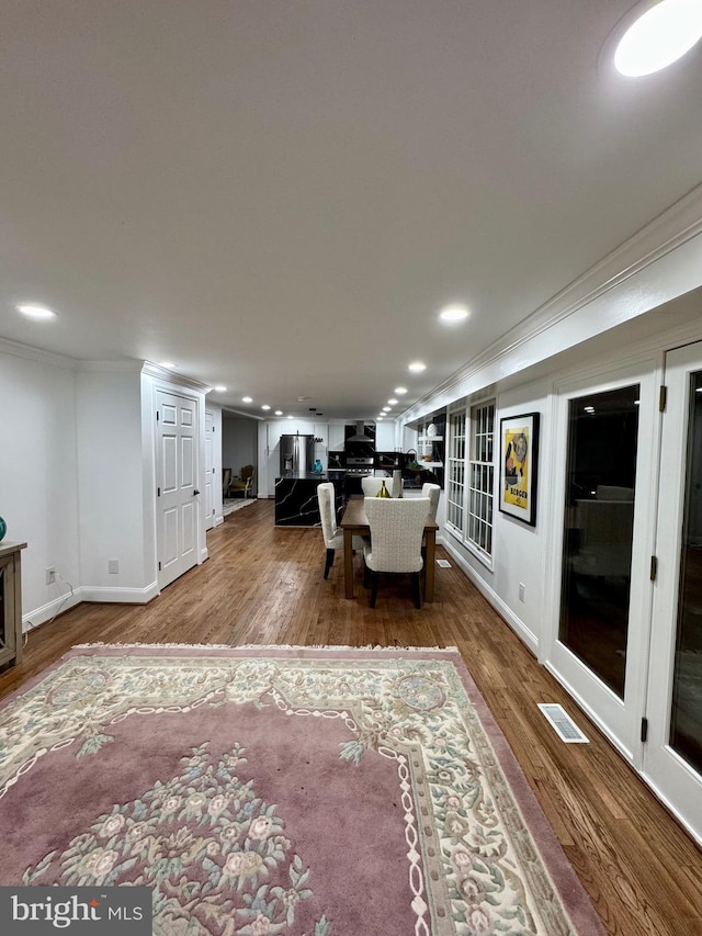 living room with hardwood / wood-style floors and ornamental molding