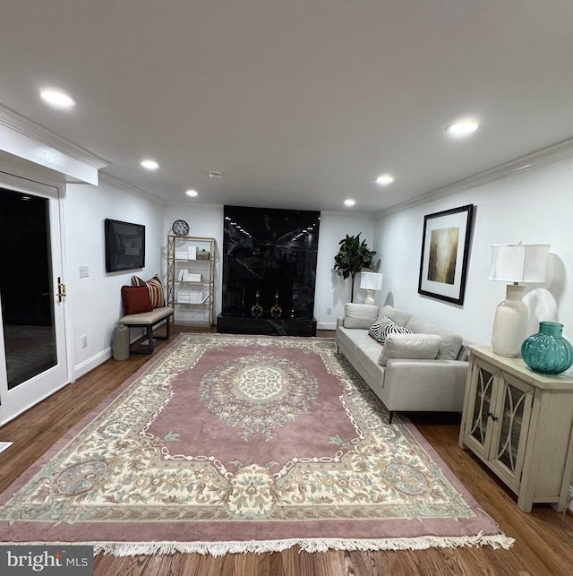 living room featuring wood-type flooring and ornamental molding