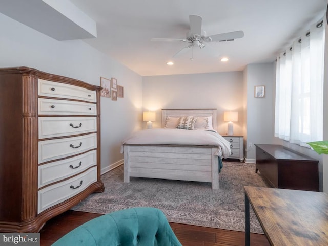 bedroom with ceiling fan and dark wood-type flooring