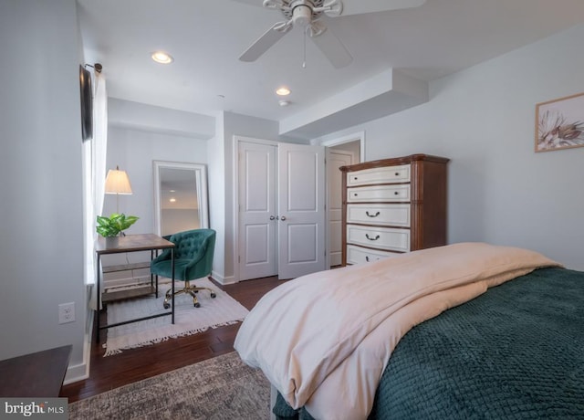 bedroom with ceiling fan, a closet, and dark wood-type flooring