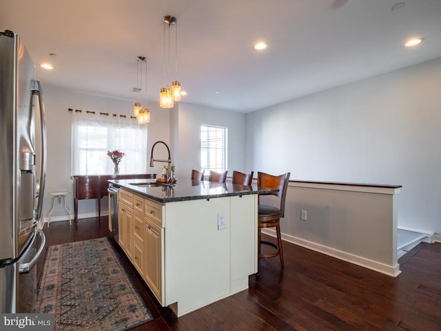 kitchen featuring pendant lighting, a center island with sink, sink, appliances with stainless steel finishes, and plenty of natural light