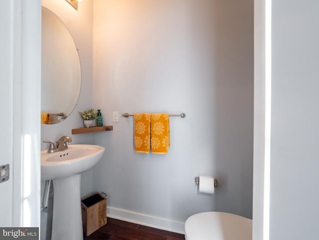 bathroom featuring sink, wood-type flooring, and toilet