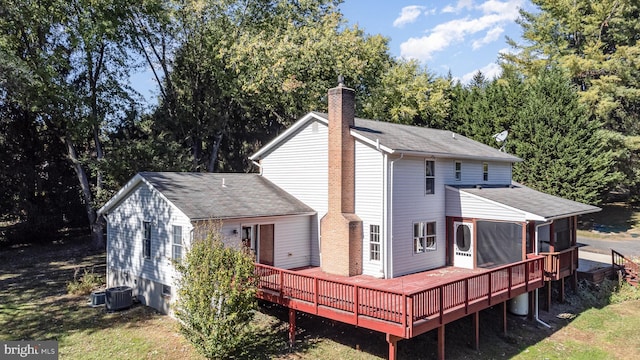 rear view of house with central AC and a wooden deck