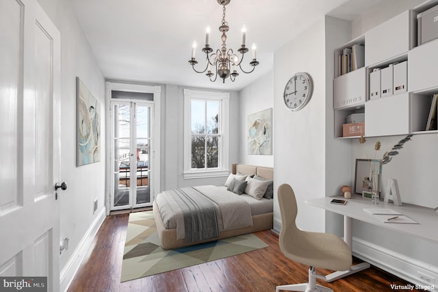 bedroom with hardwood / wood-style flooring, access to outside, visible vents, and a chandelier