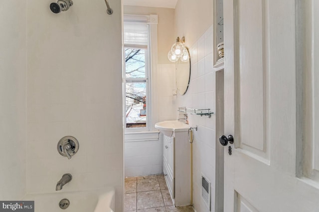 full bath featuring tile patterned flooring, bathtub / shower combination, tile walls, and vanity