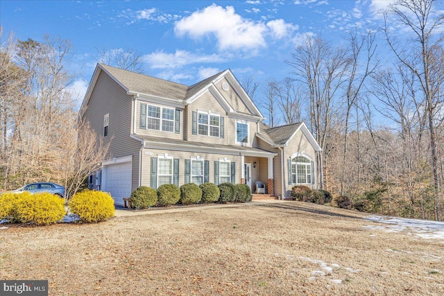 view of front of property featuring a garage and a front lawn