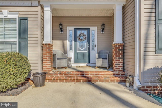 view of exterior entry featuring a porch