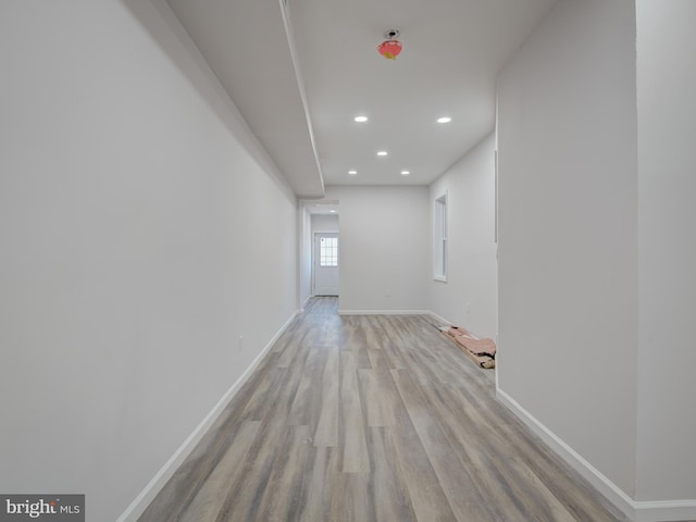 corridor with light hardwood / wood-style flooring