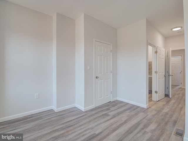 spare room with light hardwood / wood-style flooring