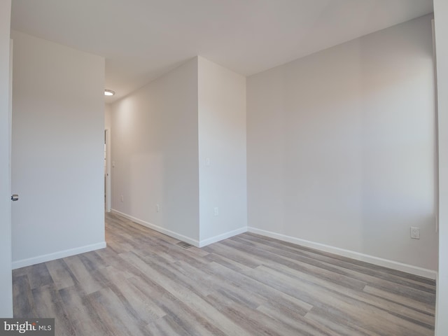 empty room with light hardwood / wood-style flooring