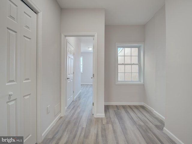 hallway with light hardwood / wood-style flooring