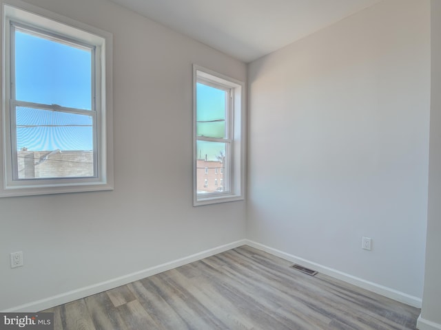 spare room featuring light hardwood / wood-style flooring