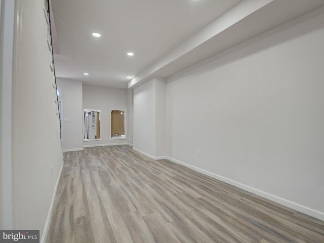 basement with light hardwood / wood-style flooring