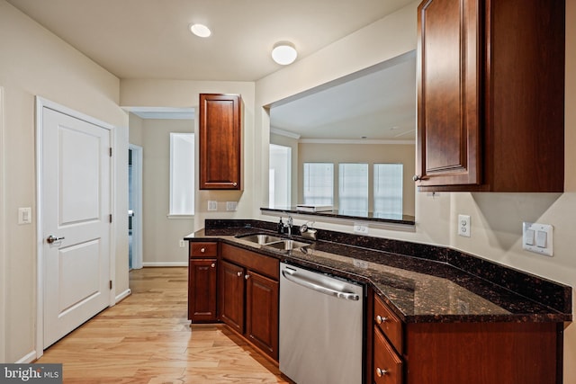 kitchen with sink, light hardwood / wood-style flooring, dark stone countertops, stainless steel dishwasher, and ornamental molding