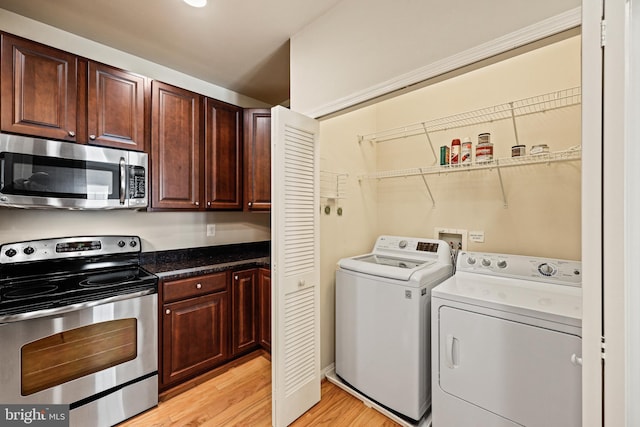 laundry area featuring washer and dryer and light wood-type flooring