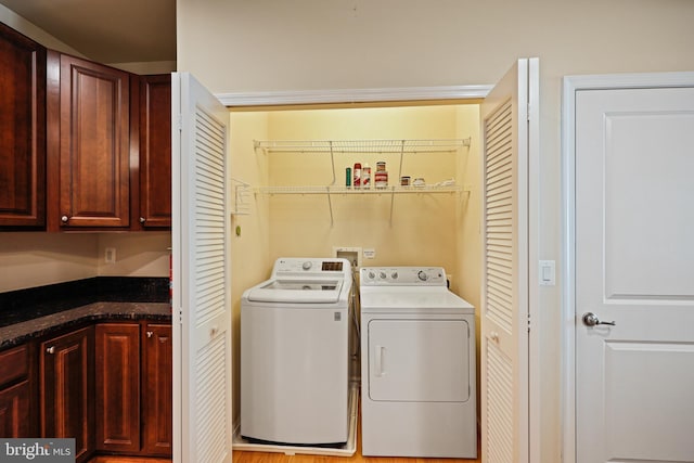 clothes washing area with washer and dryer